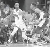  ??  ?? Heat guard Dwyane Wade (3) dribbles the ball against Wizards forward Troy Brown Jr. on Saturday.