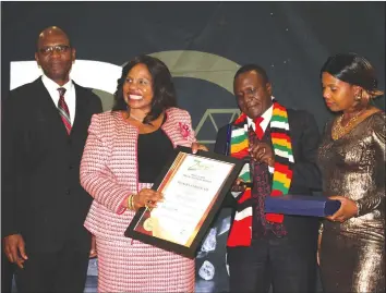  ??  ?? Minister Mutsvangwa (second from right) holding the ZNCC certificat­e awarded to her.