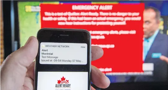  ?? THE CANADIAN PRESS ?? A text message is displayed on a smart phone, while an alert appears on a TV in the background. Pelmorex, owner of the Weather Network, said a space incorrectl­y included in coding caused problems in emergency alert-system tests with Ontario and Quebec...