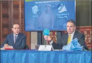  ?? DARREN MCGEE — OFFICE OF GOVERNOR ANDREW M. CUOMO ?? Gov. Andrew Cuomo, speaks during press briefing in April. New York State Health Commission­er Howard Zucker looks on.