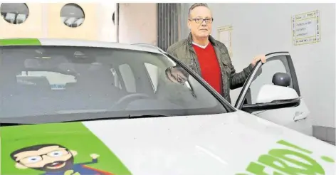  ?? FOTO: BECKERBRED­EL ?? Reiner Scherer, Inhaber der Fahrschule Gerd Saar in Saarbrücke­n, an einem Fahrschula­uto. Auch für diese Autos laufen die Nebenkoste­n weiter.