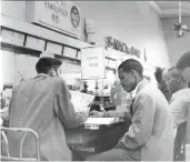  ?? STAFF PHOTO ?? Students from Howard High School participat­e in a sit-in at an allwhite lunch counter in downtown Chattanoog­a on Aug. 5, 1960.