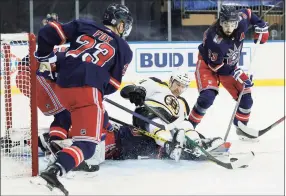  ?? Sarah Stier / Associated Press ?? The Bruins’ Nick Ritchie falls on top of Rangers goaltender Alexandar Georgiev as Mika Zibanejad (93) and Adam Fox (23) try to clear the puck from the area during the first period on Sunday in New York.