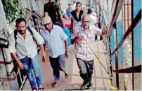  ?? PTI ?? People walk on the Elphinston­e Foot Over Bridge on Saturday which was the scene of the tragic stampede incident on Friday. —