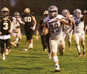  ?? Sean Patrick Bowley / Hearst Connecticu­t Media ?? Naugatuck’s Mike Dietelbaum holds up his index finger as he scoreson a 17-yard run in the second quarter of a 41-0 victory over Woodland on Friday.