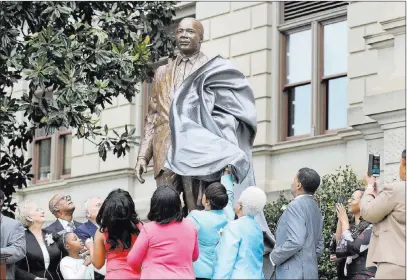  ?? David Goldman ?? The Associated Press A statue paying tribute to civil rights leader Martin Luther King Jr. is unveiled on the state Capitol grounds in his hometown of Atlanta on Monday, the 54th anniversar­y of King’s “I have a dream” speech at the march on Washington.