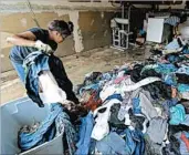  ?? DAVID J. PHILLIP/AP ?? Afhley Lluvia, left, helps her mother, Julia, remove clothing from their flood-damaged home Monday in Houston.