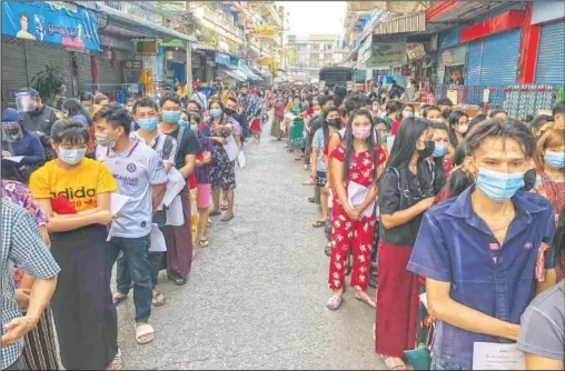  ?? (File Photo/AP/Jerry Harmer) ?? People stand in lines to get covid-19 tests in Samut Sakhon, south of Bangkok. Thailand’s lucky streak faded late last year, when a virus cluster was found among migrant workers working in factories and seafood markets and living in crowded dormitorie­s.