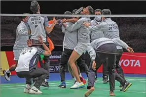  ?? (AFP) ?? Members of India’s badminton team celebrate after H.S. Prannoy won against Denmark’s Rasmus Gemke during the semi-finals of the Thomas and Uber Cup badminton tournament in Bangkok on Friday.