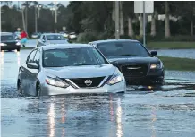  ?? SPENCER PLATT / GETTY IMAGES ?? Driving a vehicle through flooded roads is a bad idea, but if you absolutely must, be sure to take it slow.