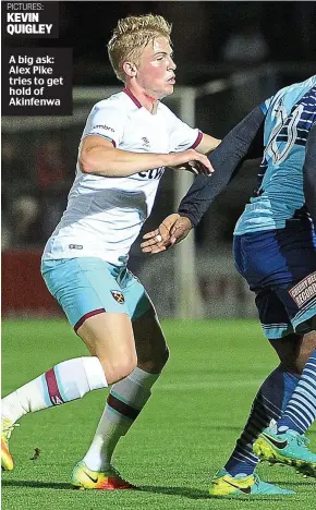  ??  ?? A big ask: Alex Pike tries to get hold of Akinfenwa PICTURES: KEVIN QUIGLEY