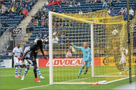  ?? MIKE REEVES — FOR DIGITAL FIRST MEDIA ?? CJ Sapong, left, heads home a goal past Montreal goalkeeper Evan Bush in the 29th minute Saturday to give the Union a 2-0 lead. The Impact rallied in the second half to salvage a 3-3 draw at Talen Energy Stadium.