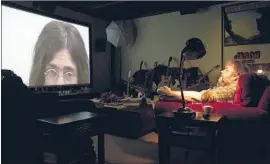 ?? Nicola Dove Walt Disney Studios ?? PETER JACKSON watches 1969 footage of John Lennon in his new documentar­y.