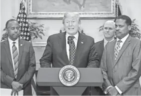  ?? JIM LO SCALZO/EPA-EFE ?? President Trump joins Secretary of Housing and Urban Developmen­t Ben Carson, left, and Isaac Newton Farris Jr., president of the Martin Luther King Jr. Center, on Friday to sign a proclamati­on honoring King.