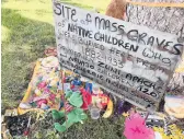  ?? SUSAN MONTOYA BRYAN/AP 2021 ?? A makeshift memorial for dozens of Indigenous children who died while attending a boarding school is displayed in Albuquerqu­e, N.M.