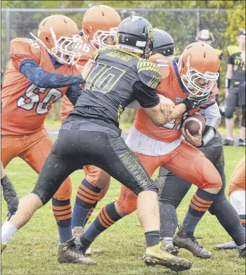  ?? TRURO NEWS PHOTO ?? CEC quarterbac­k Michael Adams bulls his way through Gri ns’ defenders Sunday in the CEC Cougars’  nal regular season game. The Cougars defeated Horton 21-9 and will play Sir John A. Macdonald Sunday in a quarter nal playo  matchup.