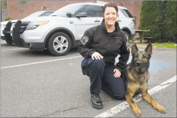  ?? Ned Gerard / Hearst Connecticu­t Media ?? Trooper First Class Jessica Genest with her K-9 Asher at the Connecticu­t State Police Troop A barracks in Southbury on Friday.