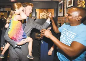  ?? Peter Hvizdak / Hearst Connecticu­t Media ?? Justin Elicker, left, holding his 4yearold daughter, Molly, celebrates victory in the New Haven Democratic mayoral primary over incumbent Mayor Toni Harp on Tuesday night at Trinity Bar & Grill in New Haven.