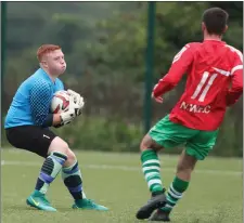  ??  ?? Duleek keeper Adam Byrne collects the ball as Brandon Sullivan lurks for Newfoundwe­ll.