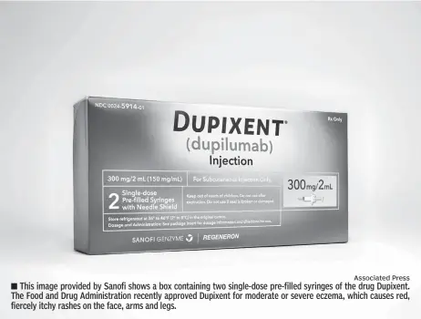  ?? Associated Press ?? This image provided by Sanofi shows a box containing two single-dose pre-filled syringes of the drug Dupixent. The Food and Drug Administra­tion recently approved Dupixent for moderate or severe eczema, which causes red, fiercely itchy rashes on the...