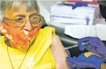  ?? ROGELIO V. SOLIS ASSOCIATED PRESS ?? Linda Busby, 74, stiffens up Wednesday as she receives the Johnson & Johnson COVID-19 vaccine at the Aaron E. Henry Community Health Service Center in Clarksdale, Miss. ‘I was scared, I’m not afraid to say that,’ she said after getting the shot.