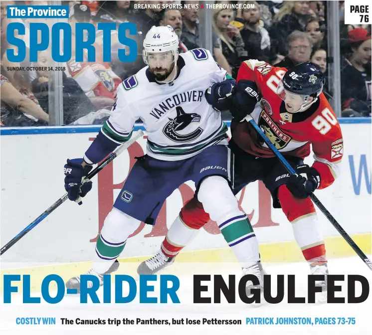  ?? —APPHOTO ?? Florida’s Jared McCann is squeezed out by Canucks’ defenceman Erik Gudbranson during Saturday’s Panthers-Vancouver game in Sunrise, Fla. Vancouver won, 3-2.