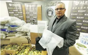  ?? IAN KUCERAK ?? Staff Sgt. Pierre Blais displays drugs seized during a large bust in Edmonton at a news conference at ALERT Edmonton on Tuesday.