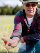  ??  ?? NWA Democrat-Gazette/JASON IVESTER MARK WHEELER OF GARFIELD shows cannonball discovered in Ruddick’s Field at the Pea Ridge National Military Park.