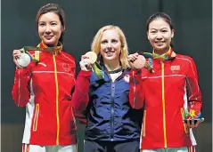  ??  ?? Precious metal: Thrasher with silver medallist Du Li (left) and Yi Siling, who took bronze