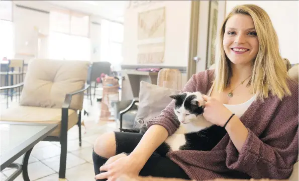  ?? MICHAEL BELL ?? Alex Baylak, owner of VegaBoo Cat Haven, sits on the cat side of the café, which is divided from the service side of the building to meet health and safety regulation­s.