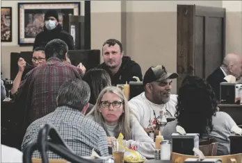  ?? AP PHOTO/DAMIAN DOVARGANES ?? Patrons eat indoors at Philippe the Original restaurant in Los Angeles, on Feb. 25.