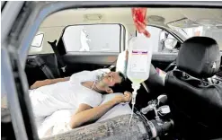  ?? —REUTERS ?? NO VACANCY A patient with breathing problems is seen inside a car while waiting to enter a COVID-19 hospital for treatment as a ferocious second wave of the disease hits Ahmedabad, India, on April 22.