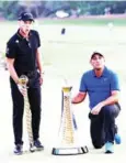  ?? AFP ?? Willett poses with the DP World Tour trophy next to Molinari and his Race to Dubai trophy.