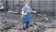  ??  ?? An injured woman appeals for help at the crash site in Tekirdag province, with the overturned train visible in the background