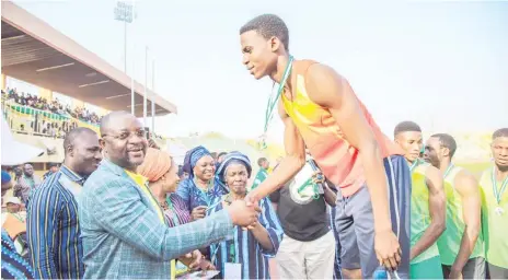  ??  ?? Minister of Youths abd Sports Developmen­t, Mr.Sunday Dare presenting medals to winners at the National Youth Games held in Ilorin, Kwara State