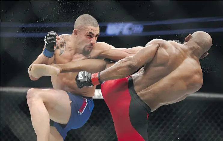  ?? — GETTY IMAGES FILES ?? Robert Whittaker and Yoel Romero trade blows Saturday in the midst of their interim middleweig­ht title bout during UFC 213 at T-Mobile Arena in Las Vegas.