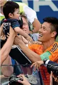 ??  ?? All smiles: Eiji Kawashima celebrates with his son