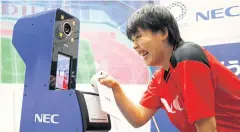  ?? REUTERS ?? Volleyball player Haruyo Shimamura demonstrat­es the face recognitio­n system.