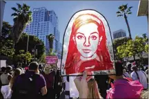  ?? AP PHOTO/CHRIS PIZZELLO ?? A Rubylith printing screen featuring a portrait of Britney Spears is held by Spears supporter Taylor Coppage outside a hearing concerning the pop singer’s conservato­rship at the Stanley Mosk Courthouse on Nov. 12 in Los Angeles. A Los Angeles judge ended the conservato­rship that has controlled Spears’ life and money for nearly 14 years.