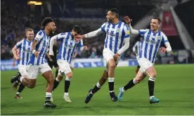  ?? Anna Gowthorpe/Shuttersto­ck ?? Jon Russell (second right) celebrates his chipped opening goal for Huddersfie­ld. Photograph: