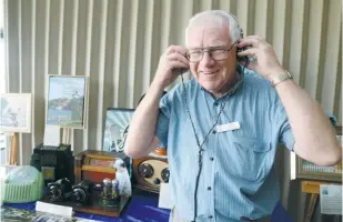  ??  ?? Ron Bowley showcases his extensive radio collection, including 1920s SG Brown headphones.