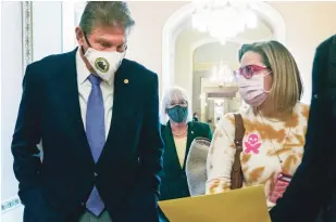  ?? JACQUELYN MARTIN/ASSOCIATED PRESS FILE PHOTO ?? Sen. Joe Manchin, D-W.Va. walks with Sen. Kyrsten Sinema, D-Ariz., after attending a Democratic policy luncheon Nov. 16 on Capitol Hill. While Manchin and Sinema’s opposition to changing Senate rules stalled the party’s signature voting legislatio­n this month, they have been reliable votes on President Joe Biden’s nominees to the courts. The two will be the center of attention as Biden moves forward with a pick to replace the retiring Justice Stephen Breyer.