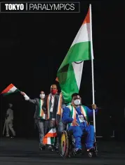  ?? — AP ?? Flag bearer Tek Chand with Indian athletes and officials during the opening ceremony for the 2020 Paralympic­s at the National Stadium in Tokyo on Tuesday.