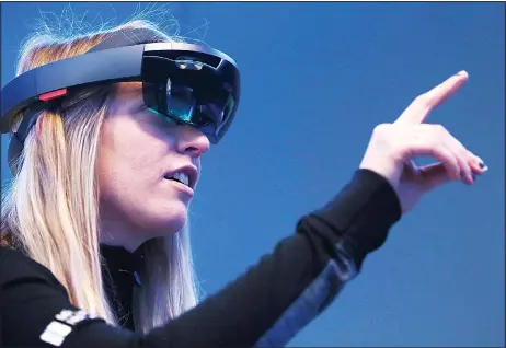  ??  ?? Microsoft employee Gillian Pennington demonstrat­es the Microsoft HoloLens augmented reality (AR) viewer during the 2016 Microsoft Build developer Conference on March 30, in San Francisco, California. The Microsoft Build Developer Conference runs through April 1. (AFP)