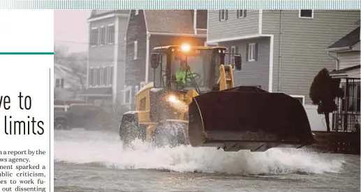  ?? AFP PIC ?? A front-end loader making its way through floodwater­s in Quincy, Massachuse­tts, on Friday.