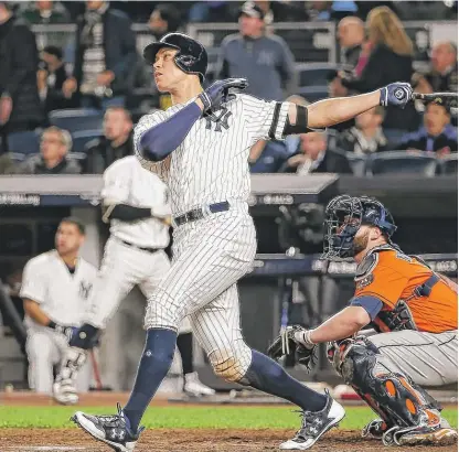  ??  ?? Yankees slugger Aaron Judge follows the flight of his home run in the seventh inning Tuesday at Yankee Stadium.