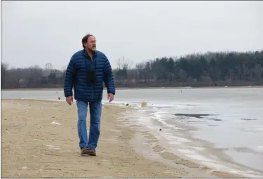  ?? BILL UHRICH — READING EAGLE ?? Ed Barrell walks along the frozen shoreline at Blue Marsh Lake.