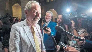  ?? JUSTIN TANG/THE CANADIAN PRESS ?? Sen. Peter Harder, the government representa­tive in the Senate, reacts to a reporter's question after passage of Bill C-45.