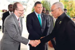  ?? ROOKWOOD/PHOTOGRAPH­ER LIONEL ?? From left: Ambassador Irwin LaRoque, secretary general of CARICOM, and Prime Minister Andrew Holness welcome President of Guyana David Granger on his arrival at the Montego Bay Convention Centre for the start of the 39th Regular Meeting of CARICOM...