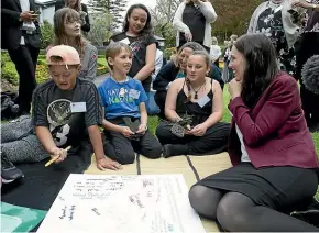  ?? ROSS GIBLIN/STUFF ?? Above: Prime Minister Jacinda Ardern talks with children from Naenae Clubhouse at a picnic at Premier House to thank children and young people involved in the child wellbeing strategy. Below: Ardern with partner Clarke Gayford with baby Neve in the pram.